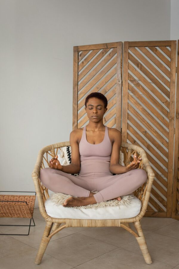 A Woman Doing a Yoga Exercise on a Chair